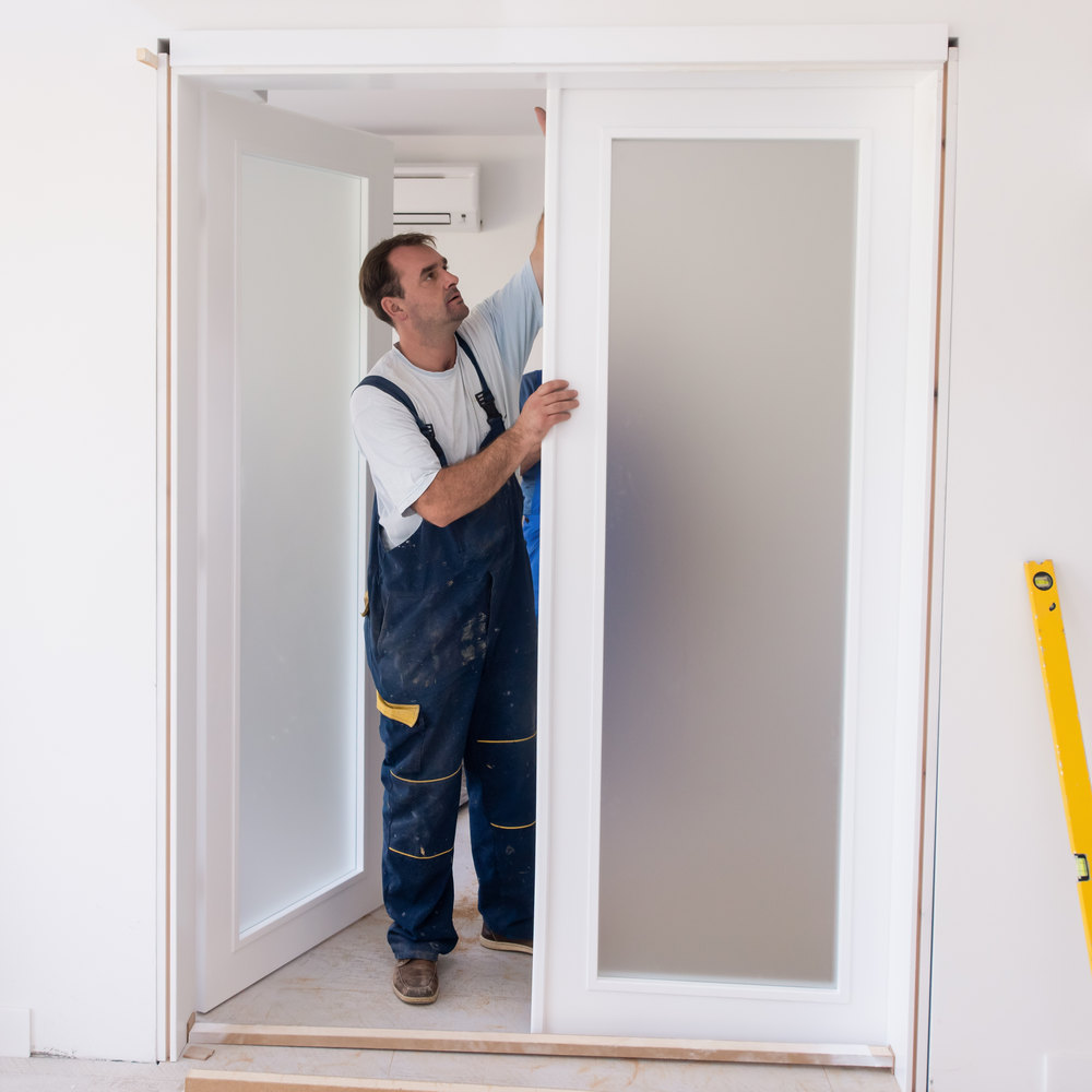 Male,Workers,Carpenters,Installing,Interior,Glass,Door,With,A,Wooden